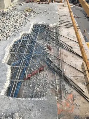 Post-tension tendon repair on a concrete slab